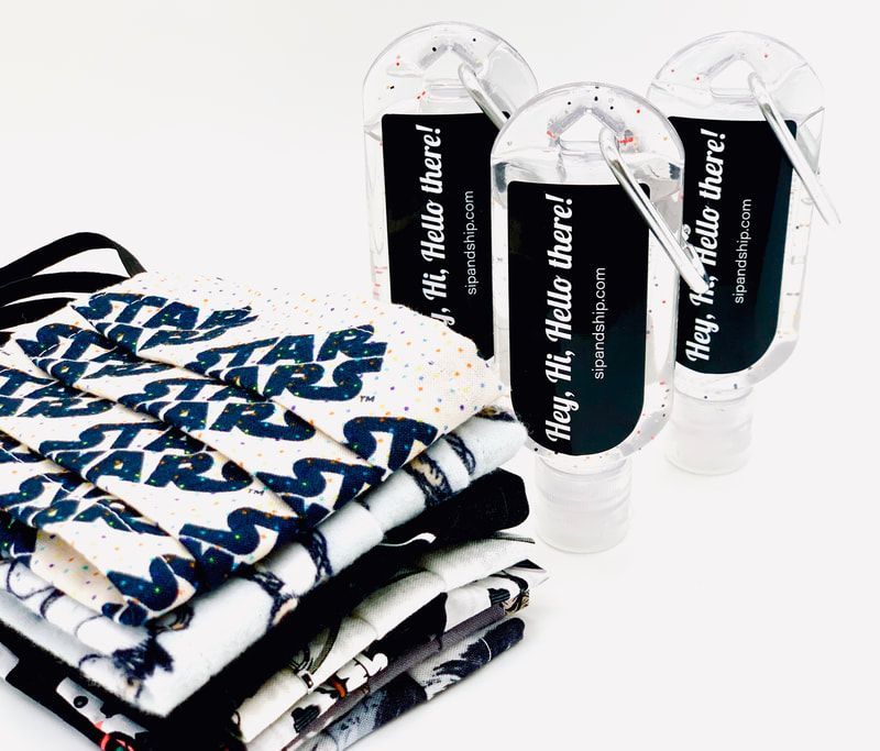 Stacked folded white-and-blue apparel with bold text beside clear water bottles with black labels