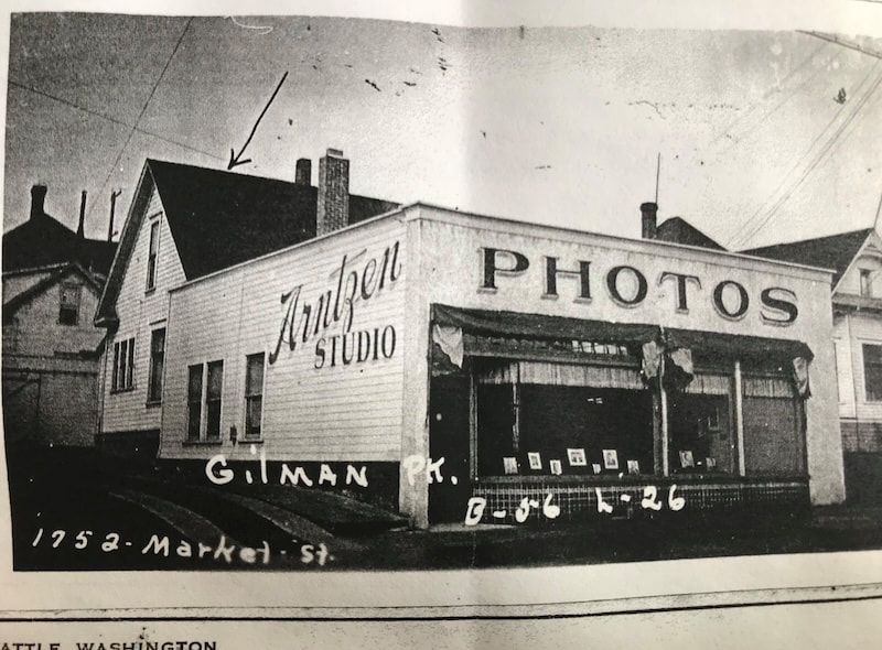 Old storefront with “PHOTOS” sign and “Anker Studio” lettering on a corner building.