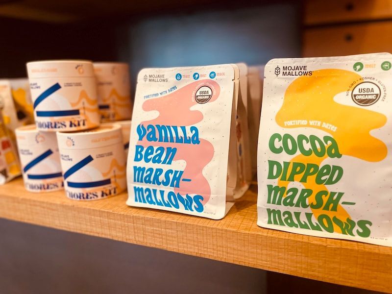 Snack shelf with two cocoa dipped marshmallows packs and a vanilla bean marshmallow pack