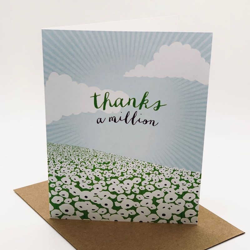 Greeting card reading “thanks a million” in green script over a sky and flower field design