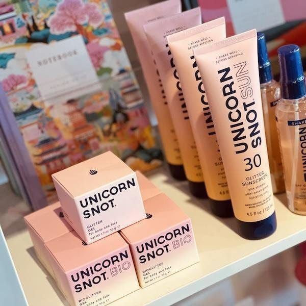 Pink Unicorn Snot skincare tubes and boxes displayed on a store shelf