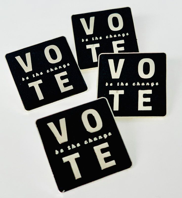 Four black stickers spelling “VOTE” in white letters on a white background.