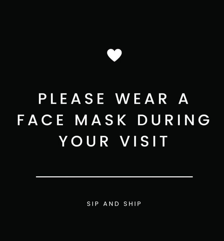 Black sign with white heart and text: “Please wear a face mask during your visit.”