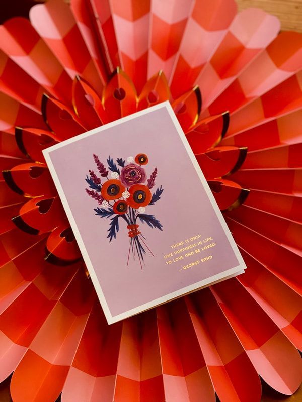 Floral card on a red and pink paper fan backdrop