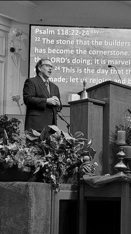 Pastor Byron is standing at a podium, giving a sermon at first baptist inverness church
