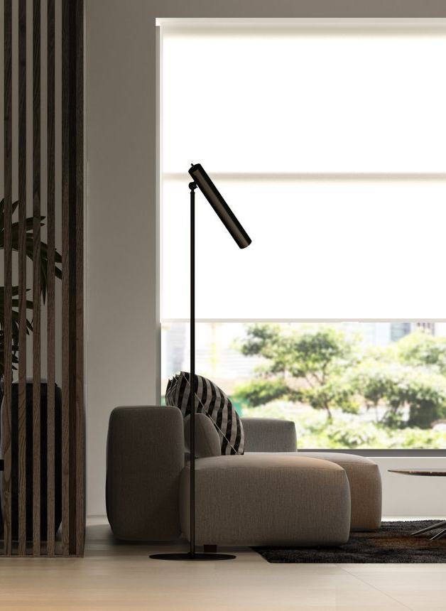 Minimalist living room with beige sofa, black floor lamp, and large window overlooking greenery