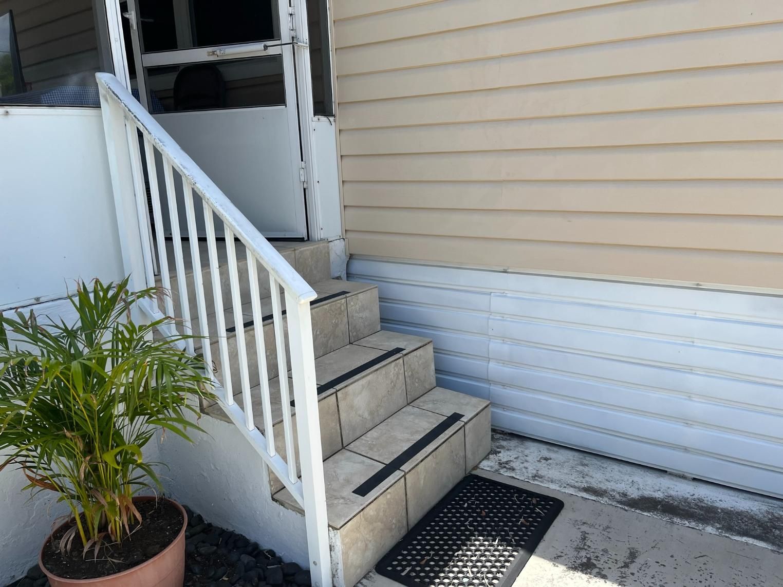 A set of stairs leading up to the front door of a house.