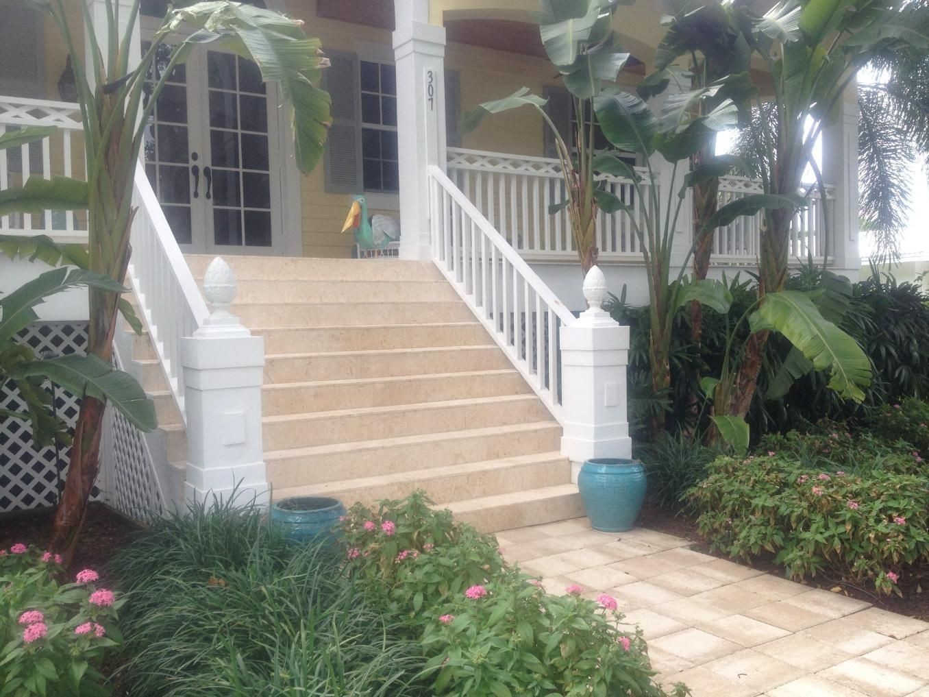 A house with stairs leading up to the front door.