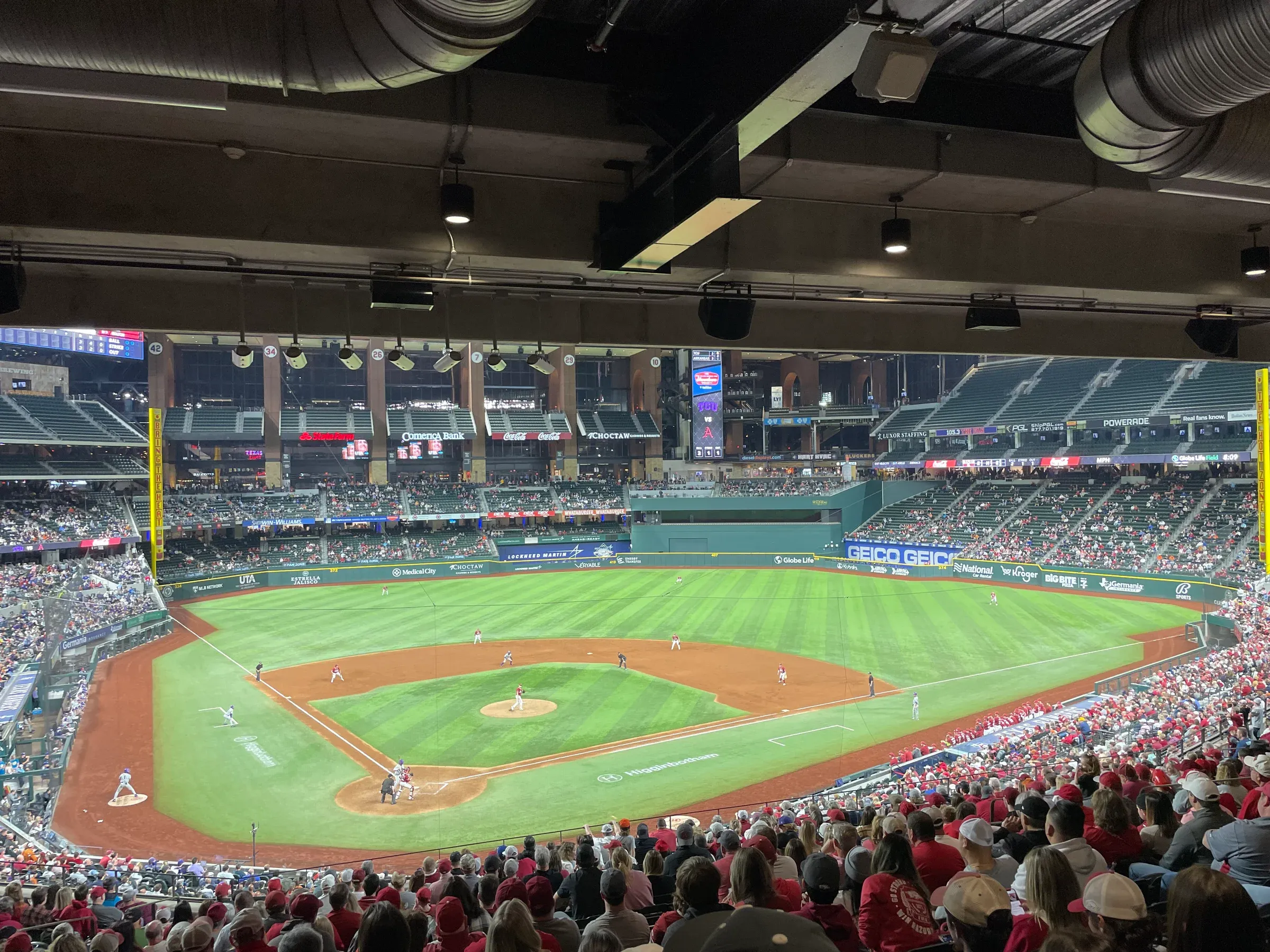 Baseball stadium filled with spectators; field view.