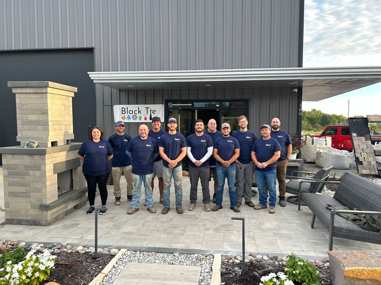Group of people posing outside a building with 