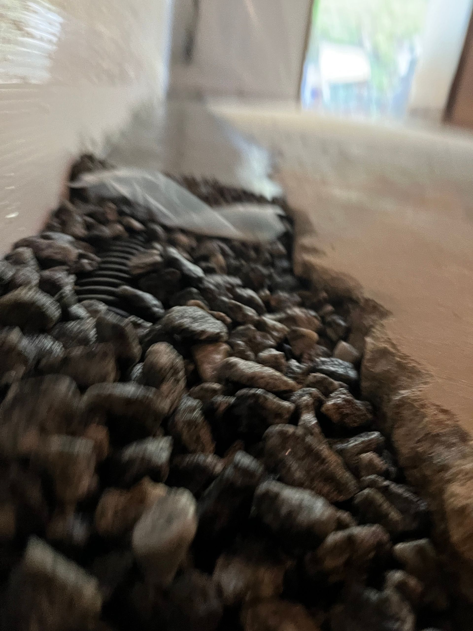 Close-up of a gravel path with a blurred tunnel-like background