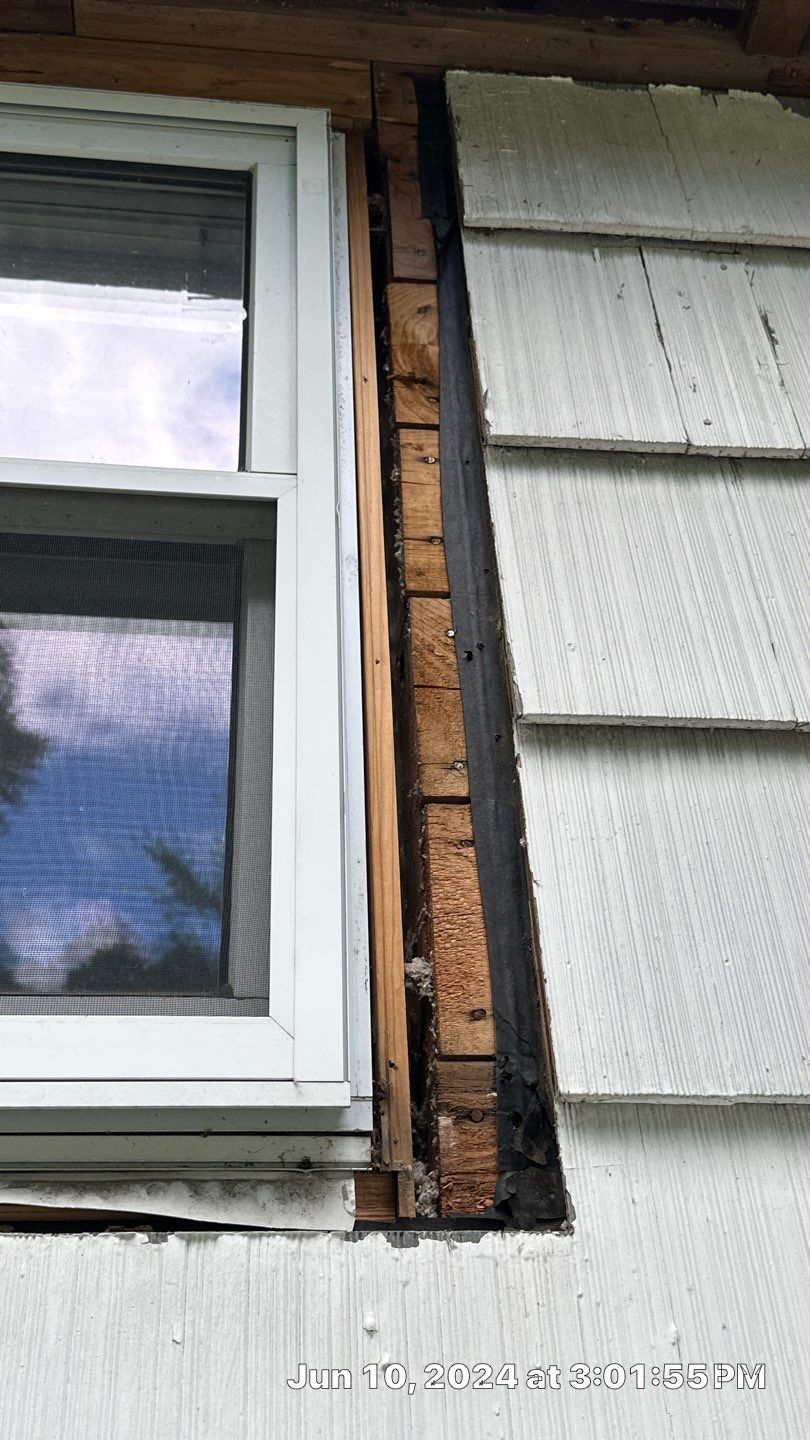 A window is missing from the side of a house.