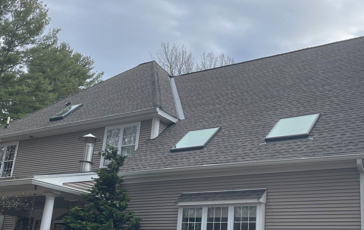 A house with a roof that has two skylights on it.