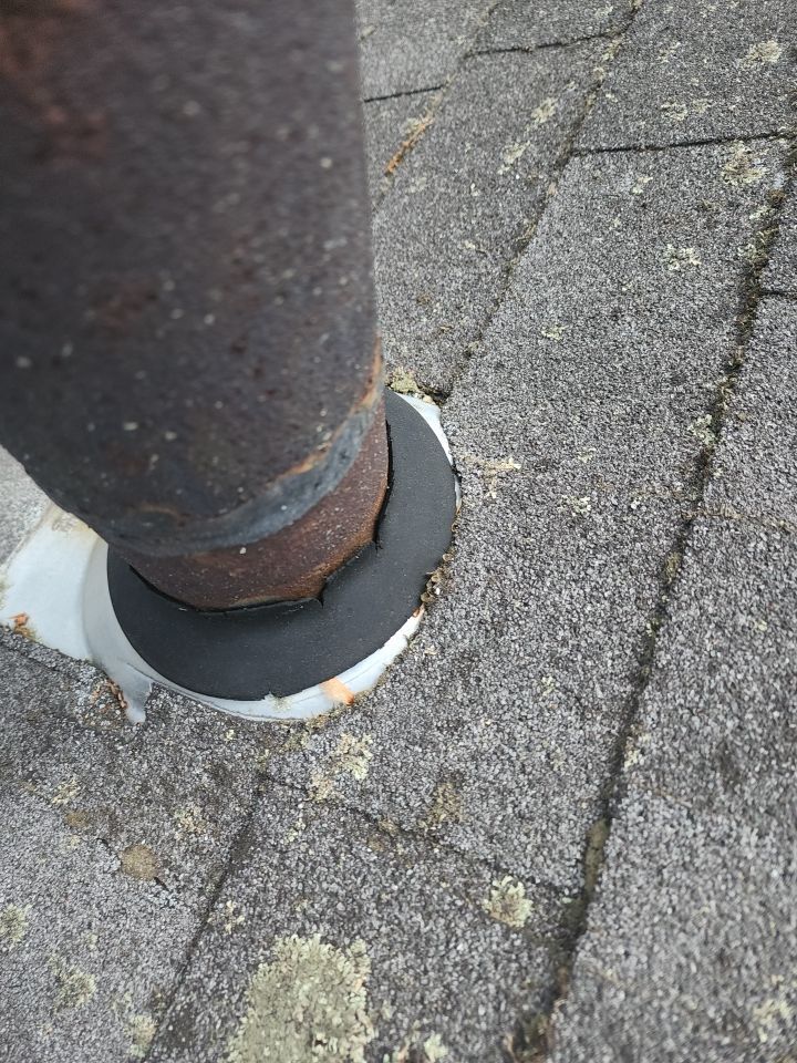 A close up of a pipe on a brick sidewalk.