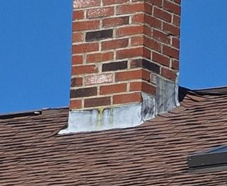 Chimney showing old and worn flashing