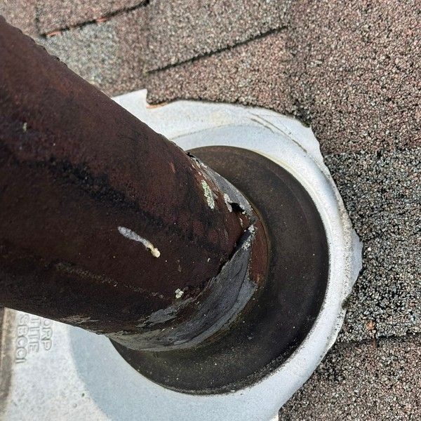 Cracked rubber pipe boot seal around a roof vent pipe