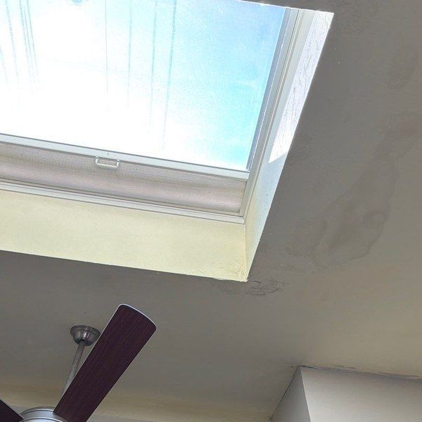 Water staining on the ceiling around a leaking skylight in a Blackstone MA home