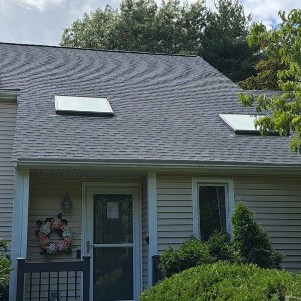 Completed roof replacement with new skylights on a Blackstone MA home