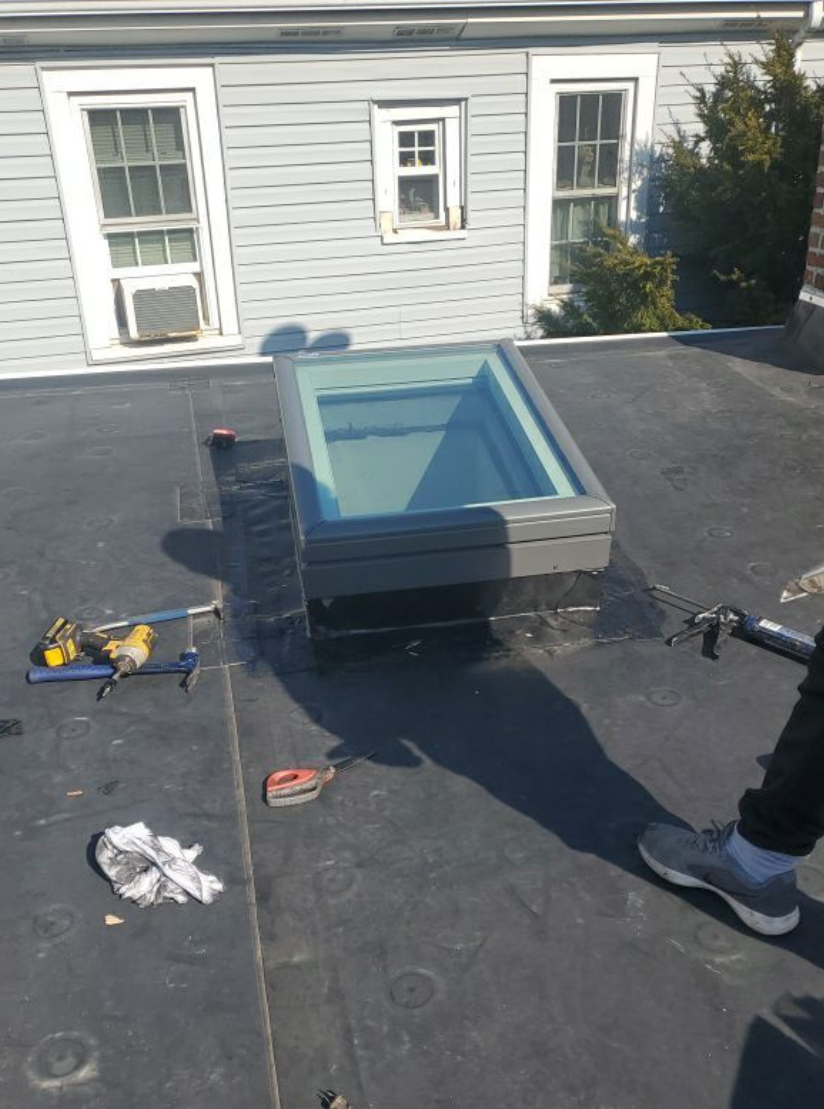 There are two skylights on the roof of a building.