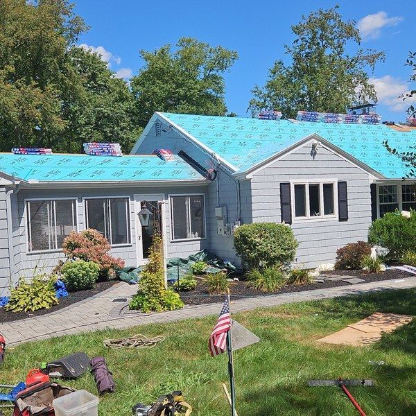 Full roof of a Fitchburg MA ranch home covered in GAF underlayment before shingle installation