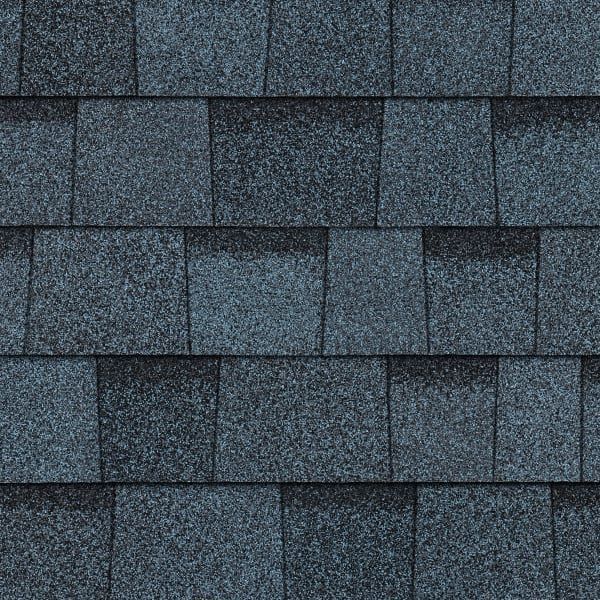 A close up of a row of gray shingles on a roof.