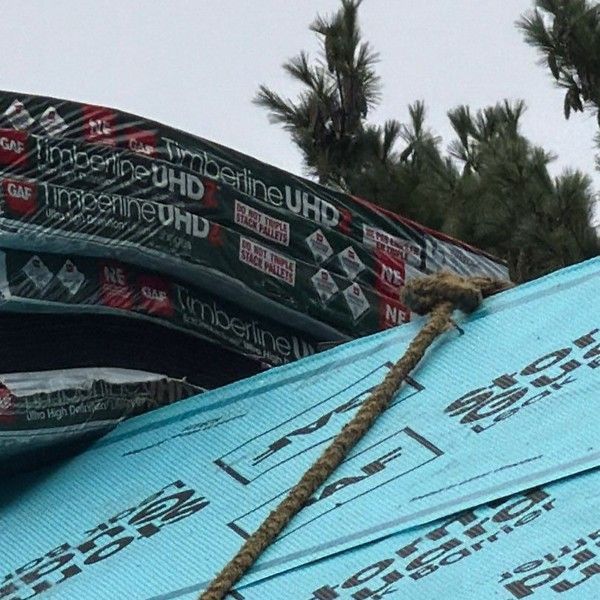Bundles of GAF Timberline UHDZ shingles staged on a roof during installation