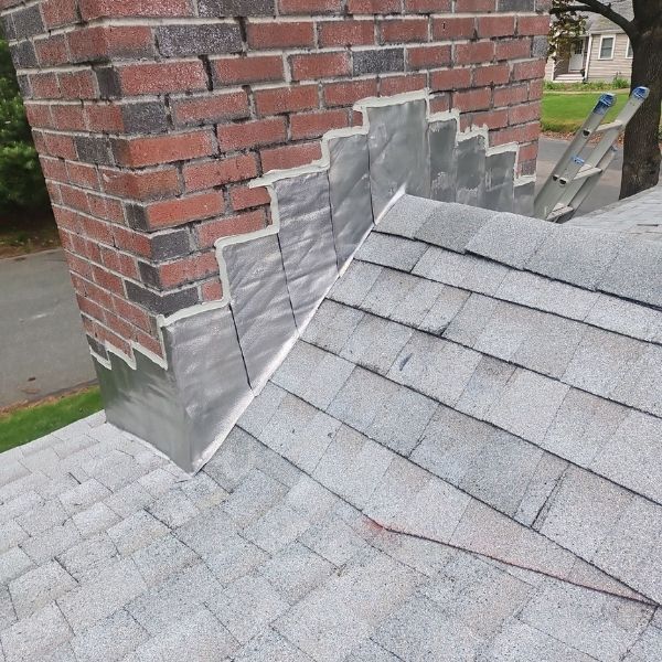 Repaired chimney with new flashing and shingles