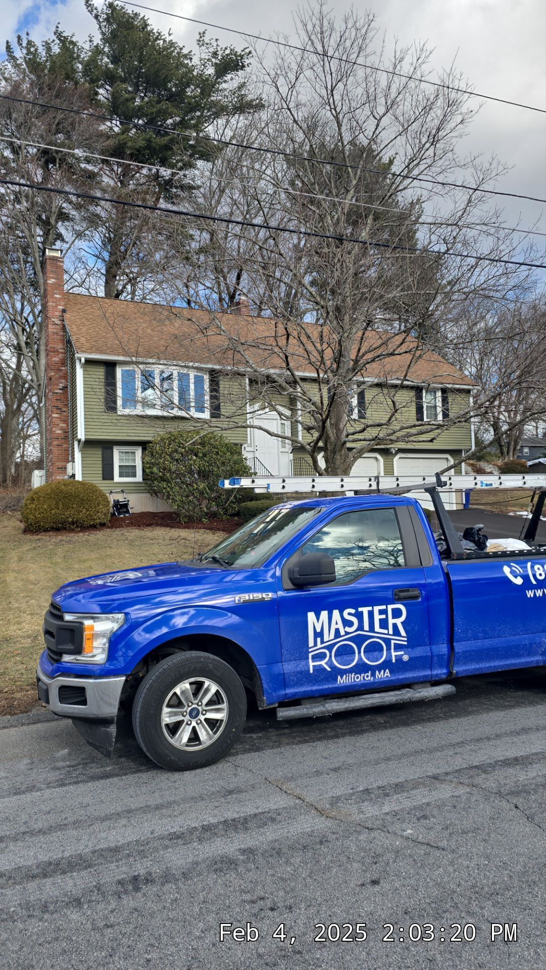 Master Roof truck in front of a house