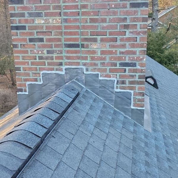 Newly flashed chimney and new roofing