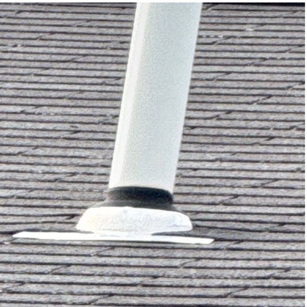 White pole base on a gray, horizontal-striped surface.