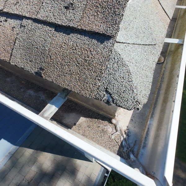 Shingle granules and debris collected in a gutter on a Medfield MA home