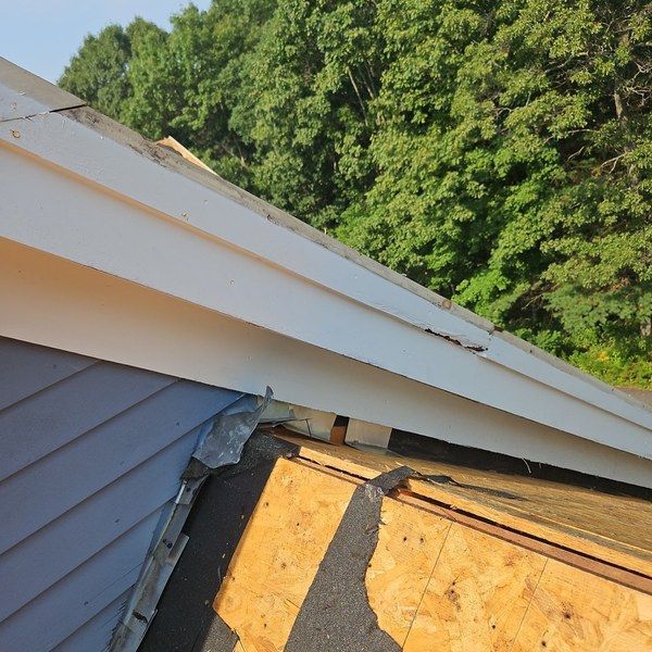 Rot at the eave and sidewall exposed during roof tear-off on a Medfield MA home