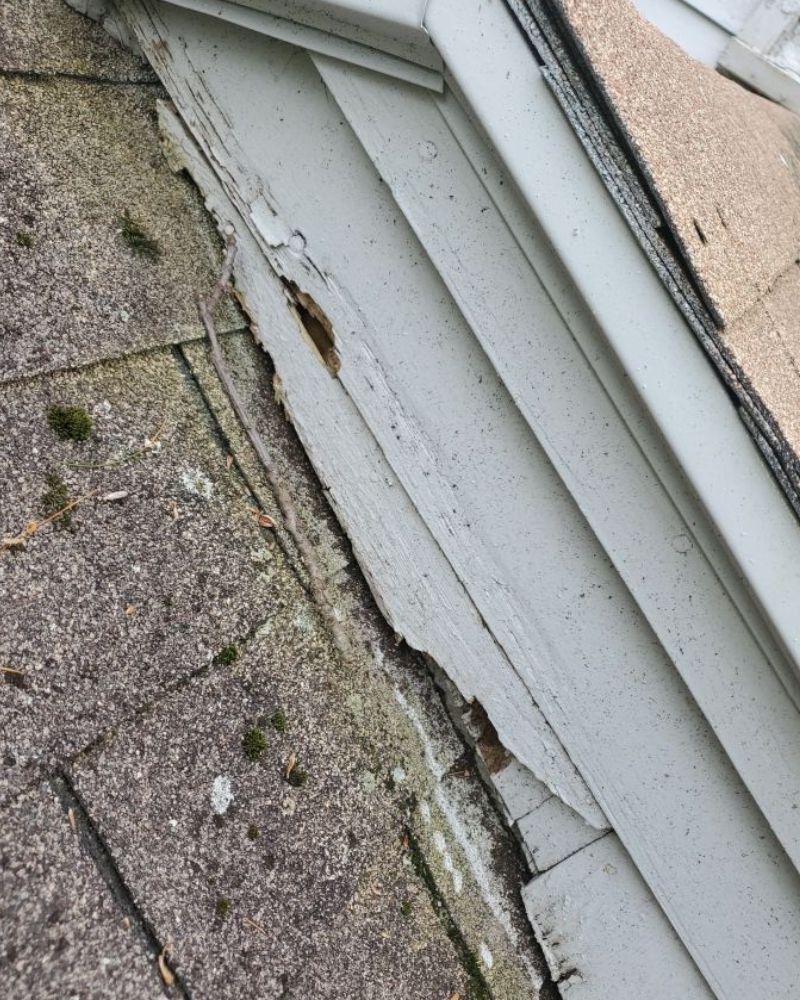A corner of a building with a broken window frame