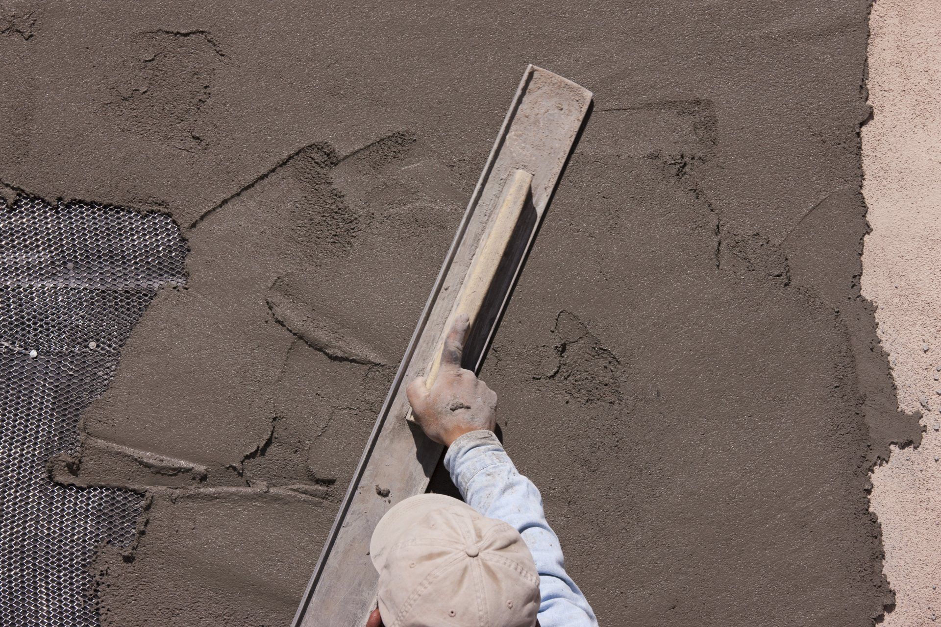 man completing a patch stucco repair job in mesa