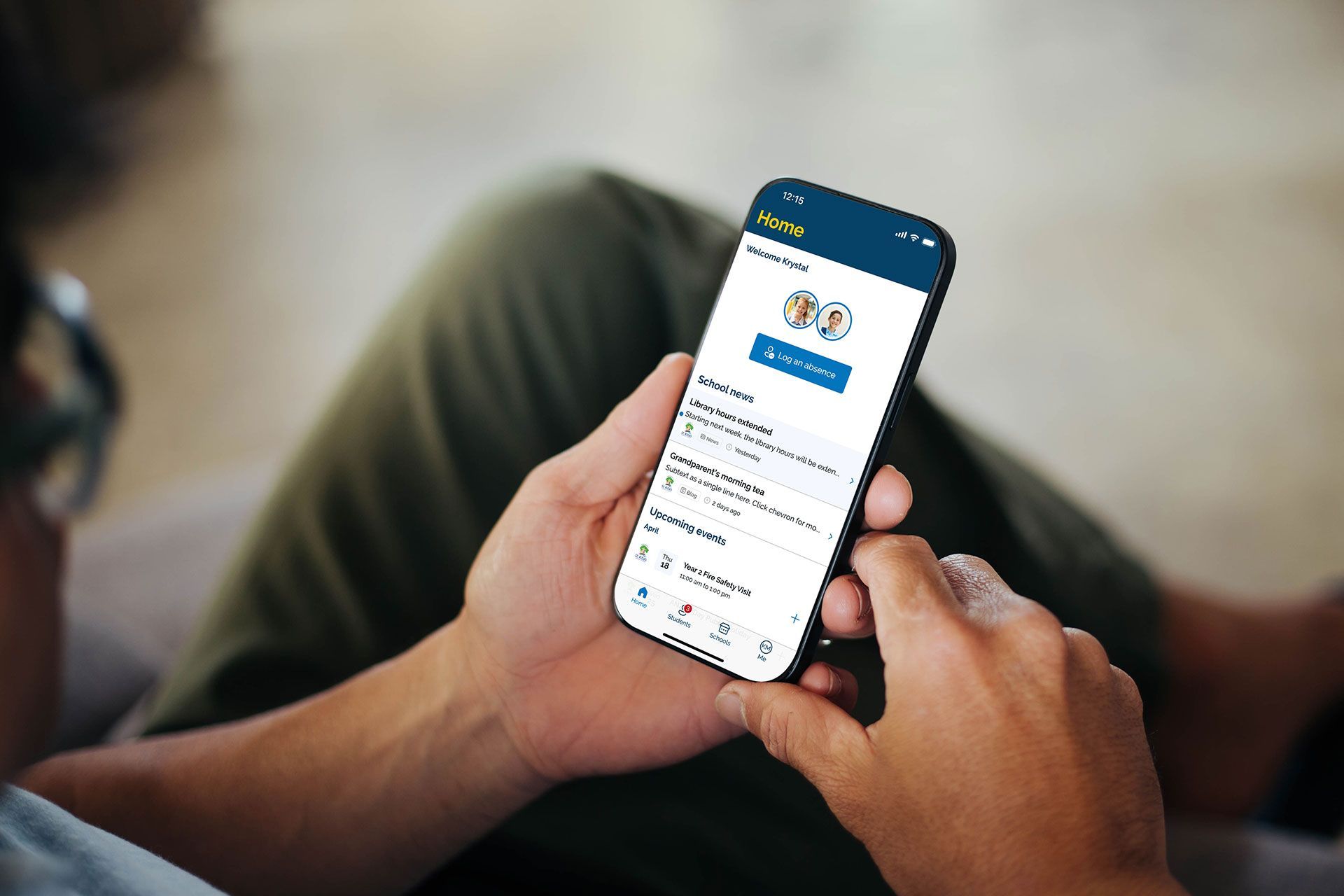 A man is sitting on a couch looking at the BCE Connect app on a mobile phone.