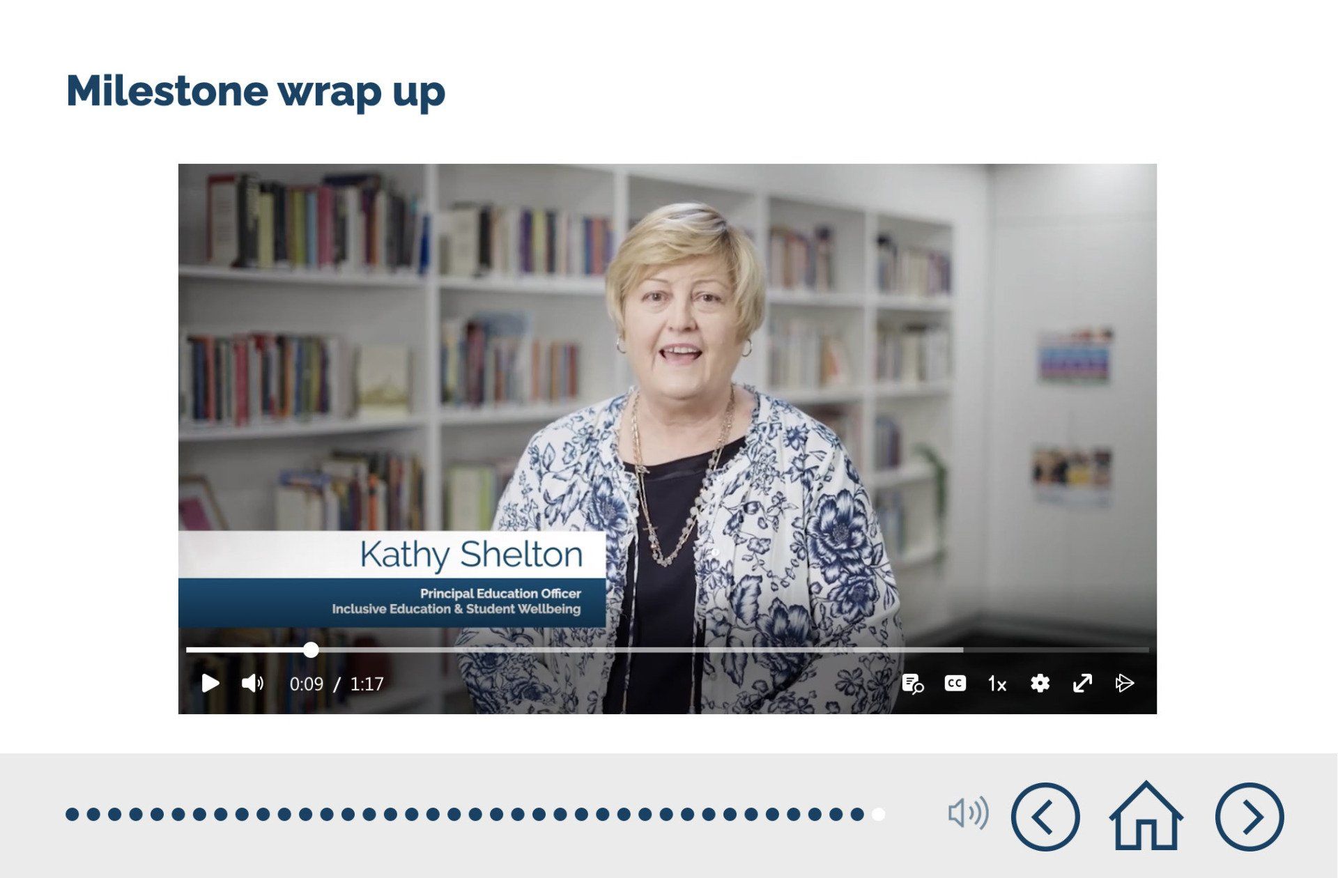 A woman is standing in front of a bookshelf in a video.