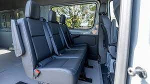 The inside of a van with a lot of seats and a window.