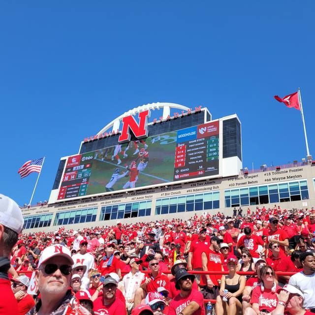 The stadium scoreboard against a clear blue sky