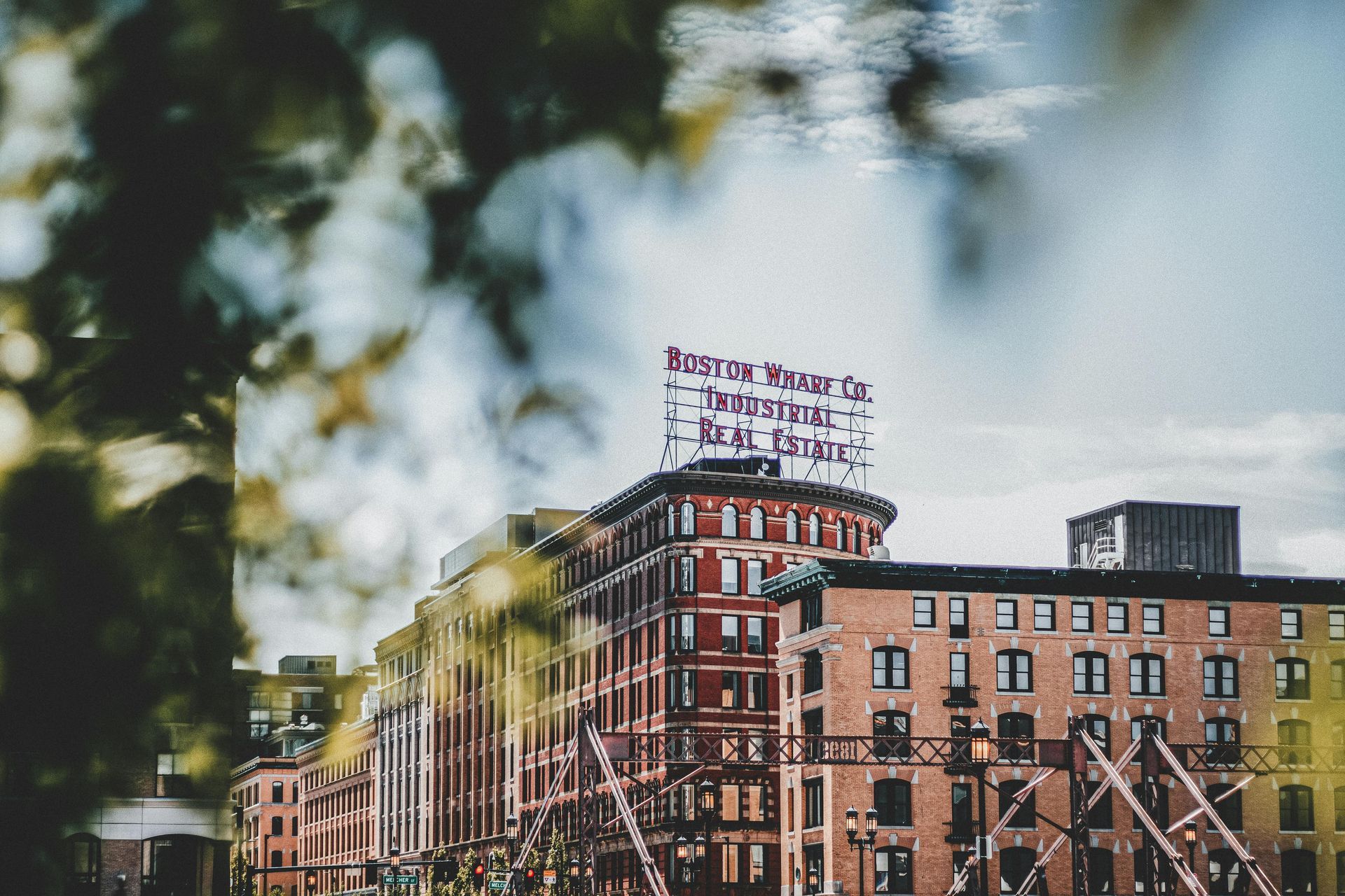 A large brick building with a sign on top of it.