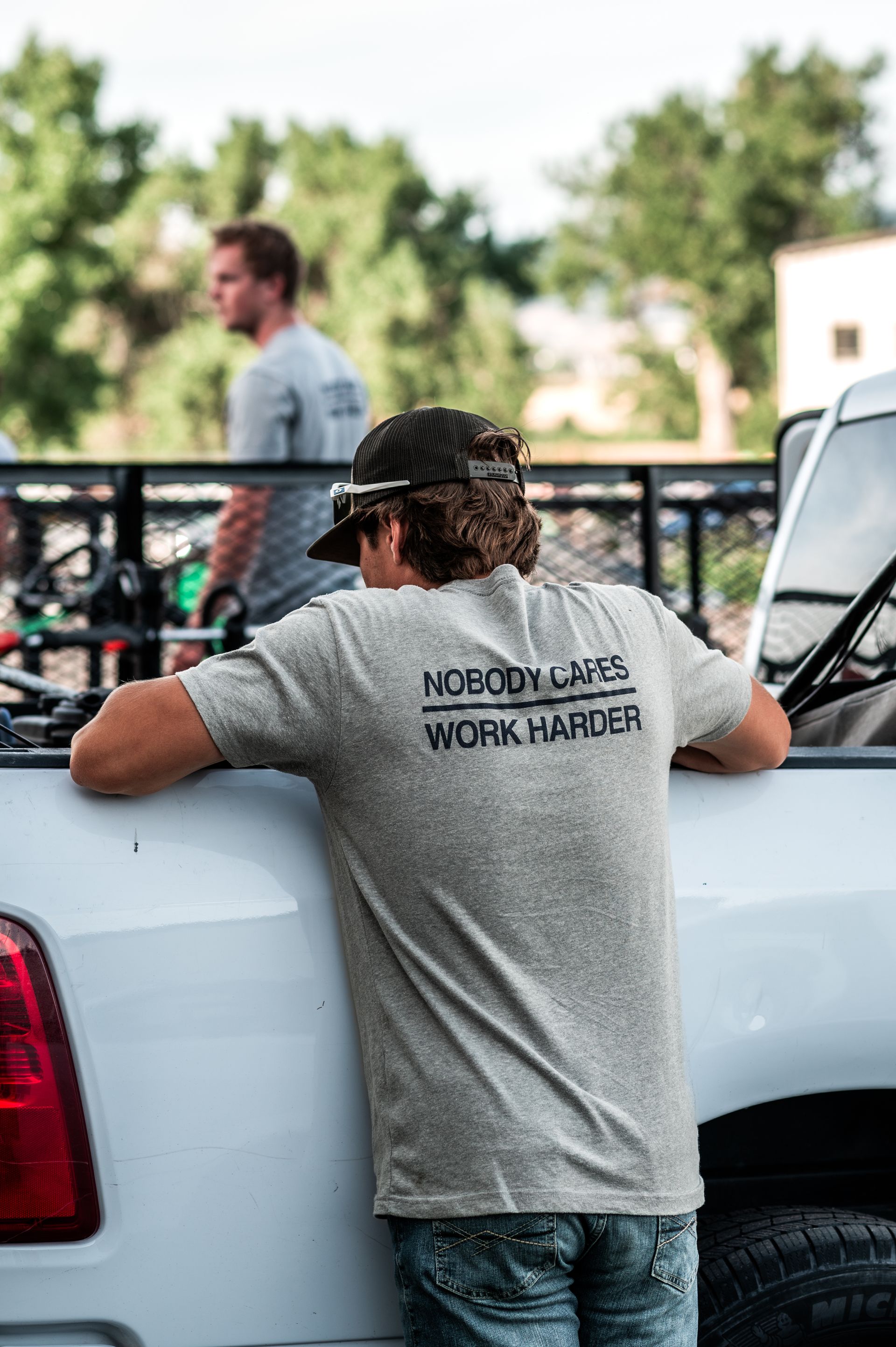Halftime Help student-athlete crew member preparing equipment in truck bed before lawn care service in south Denver metro