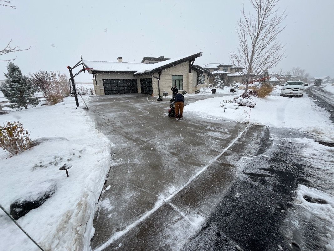 Clearing a snowy residential driveway in Highlands Ranch Colorado
