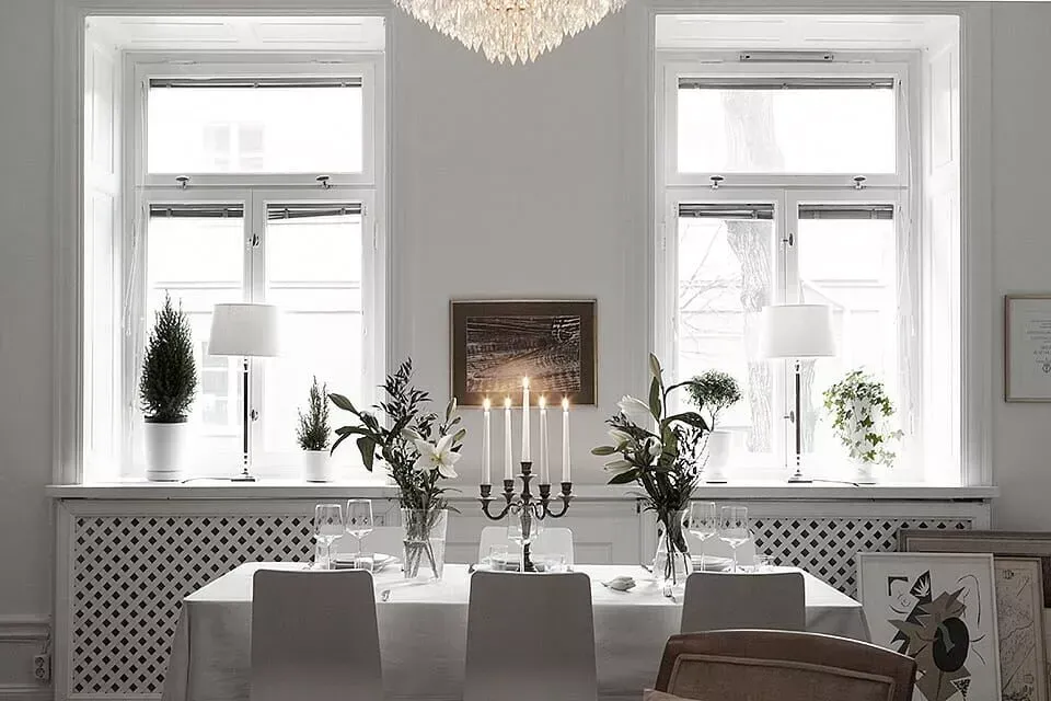 O sufragerie cu o masa si scaune si un candelabru.