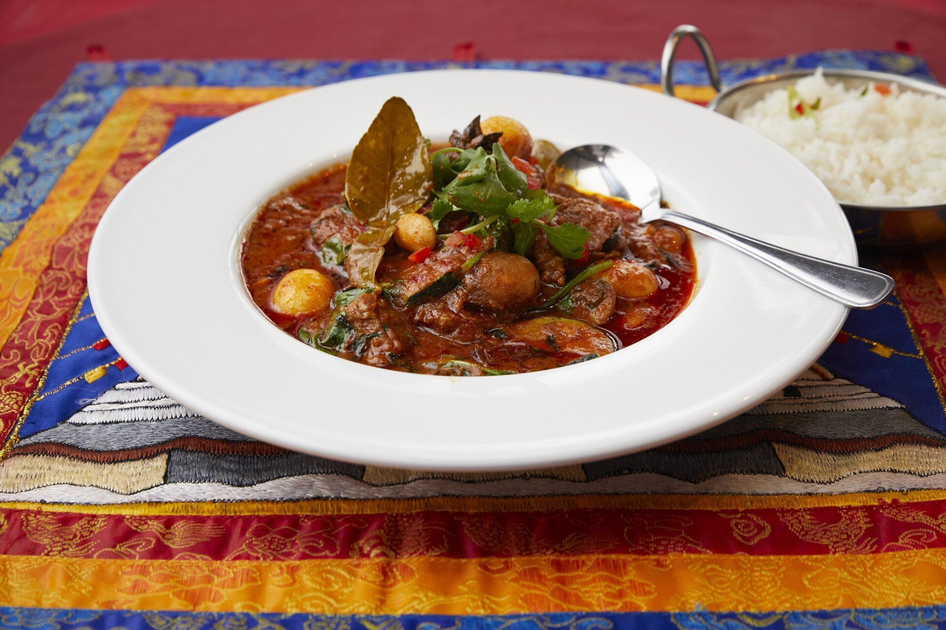 Bowl of Stew With a Spoon and a Bowl of Rice — Kathmandu Kitchen in Kingscliff, NSW