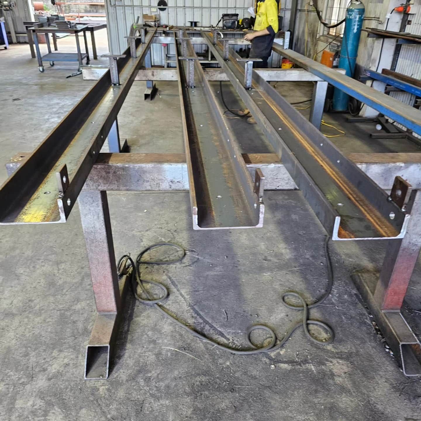A bunch of metal pieces are laying on the floor — On The Spot Steel Fabrication in Caloundra West, QLD
