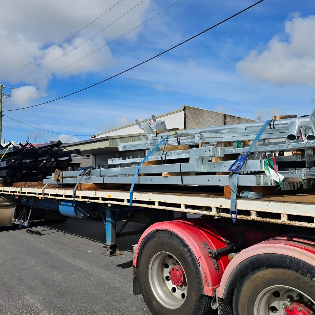 Flatbed Truck is Carrying a Stack of Steel Beams — On The Spot Steel Fabrication in Caloundra West, QLD