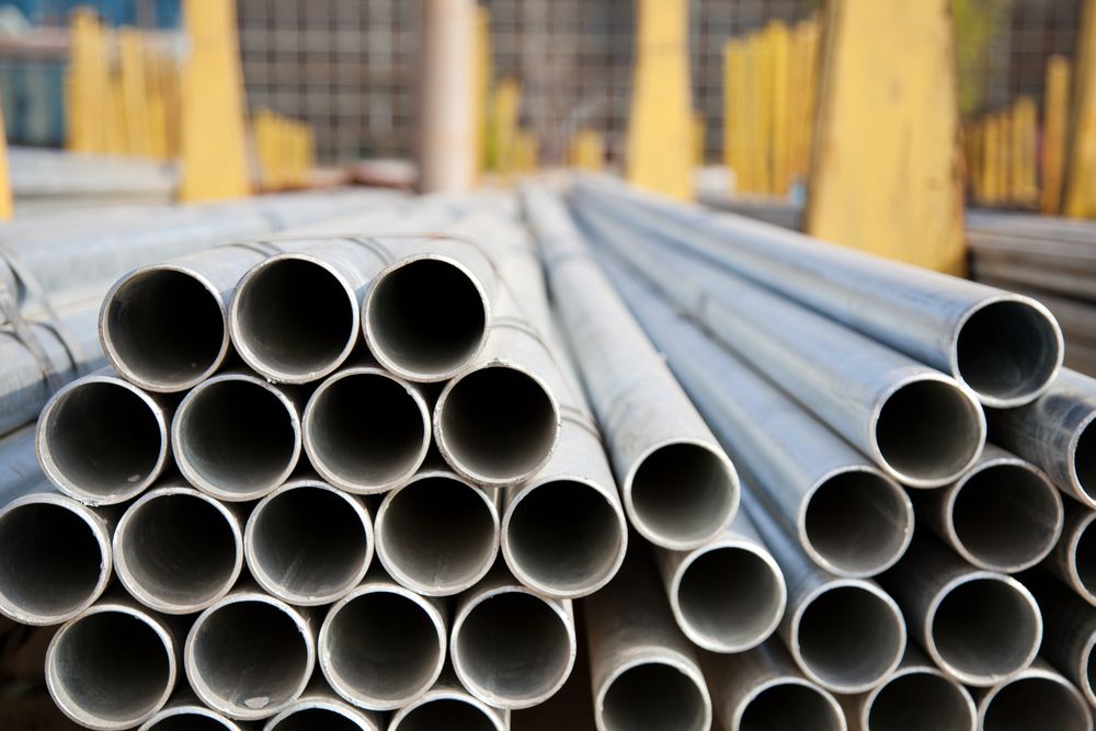 A Bunch of Metal Pipes Are Stacked on Top of Each Other — On The Spot Steel Fabrication in Caloundra West, QLD