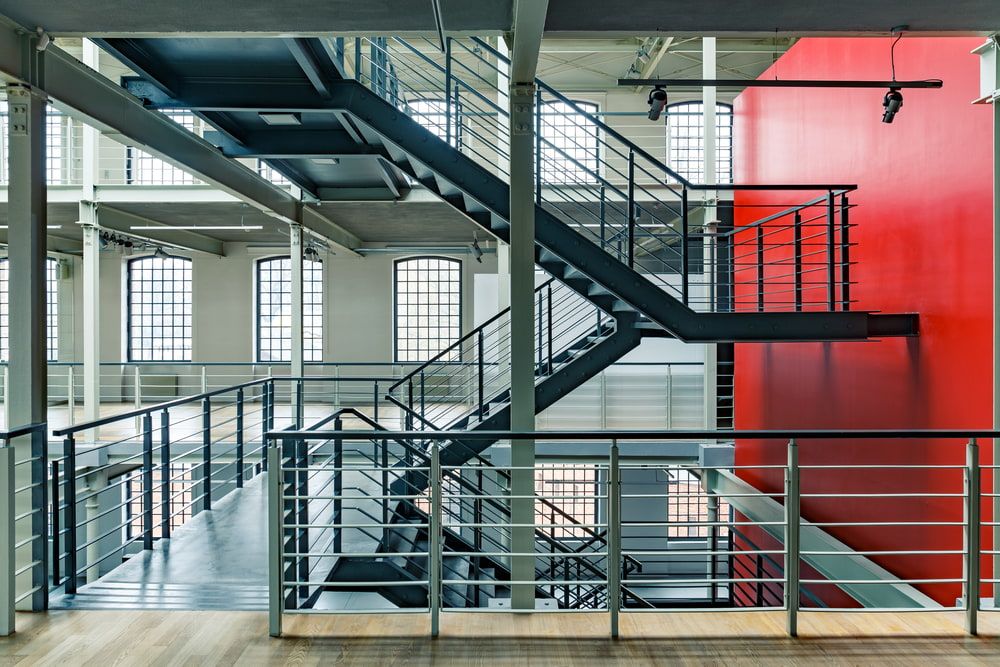 A large building with stairs and a red wall — On The Spot Steel Fabrication in Caloundra West, QLD