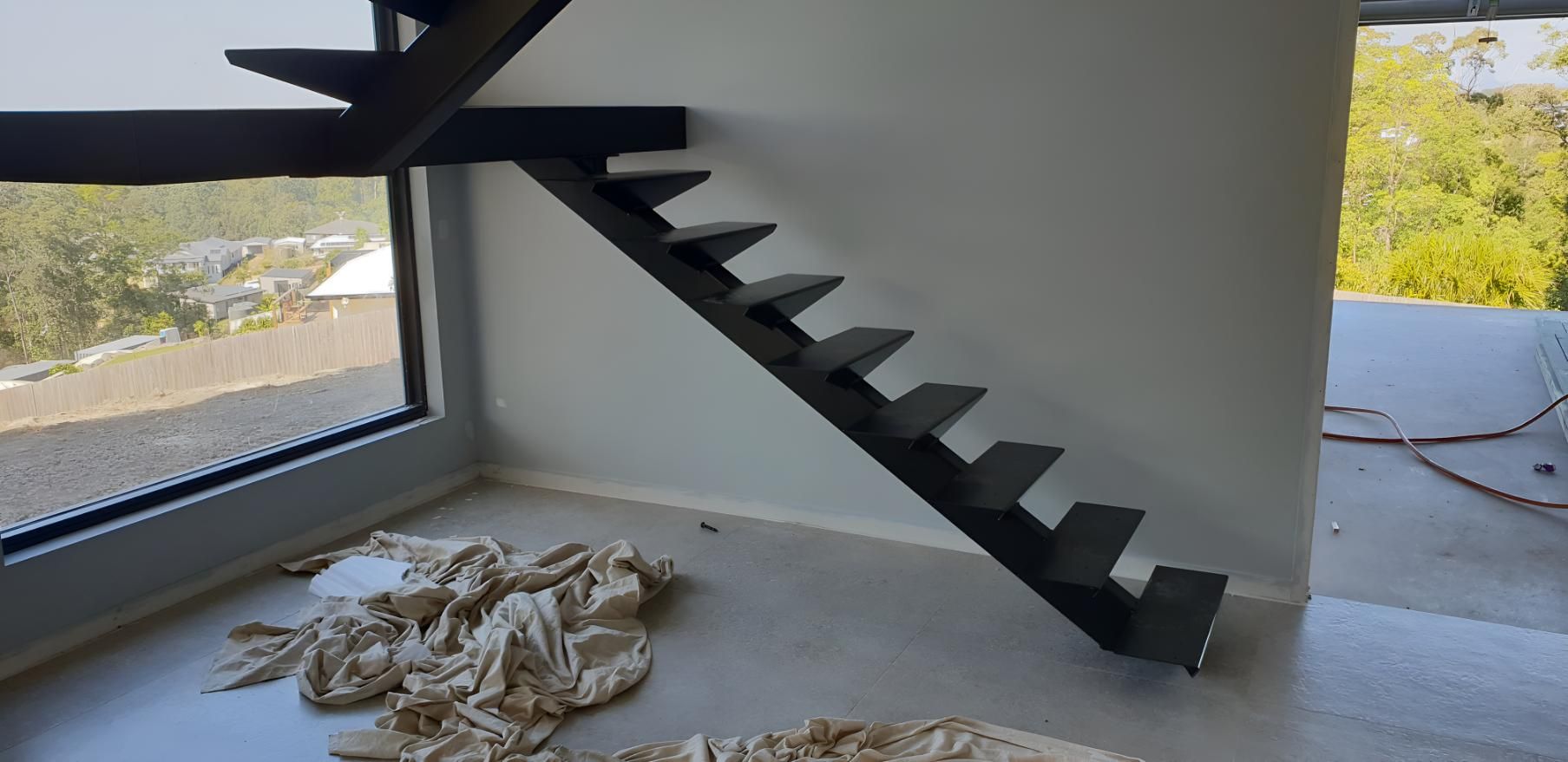 Black Staircase is in a Room Next to a Window — On The Spot Steel Fabrication in Caloundra West, QLD