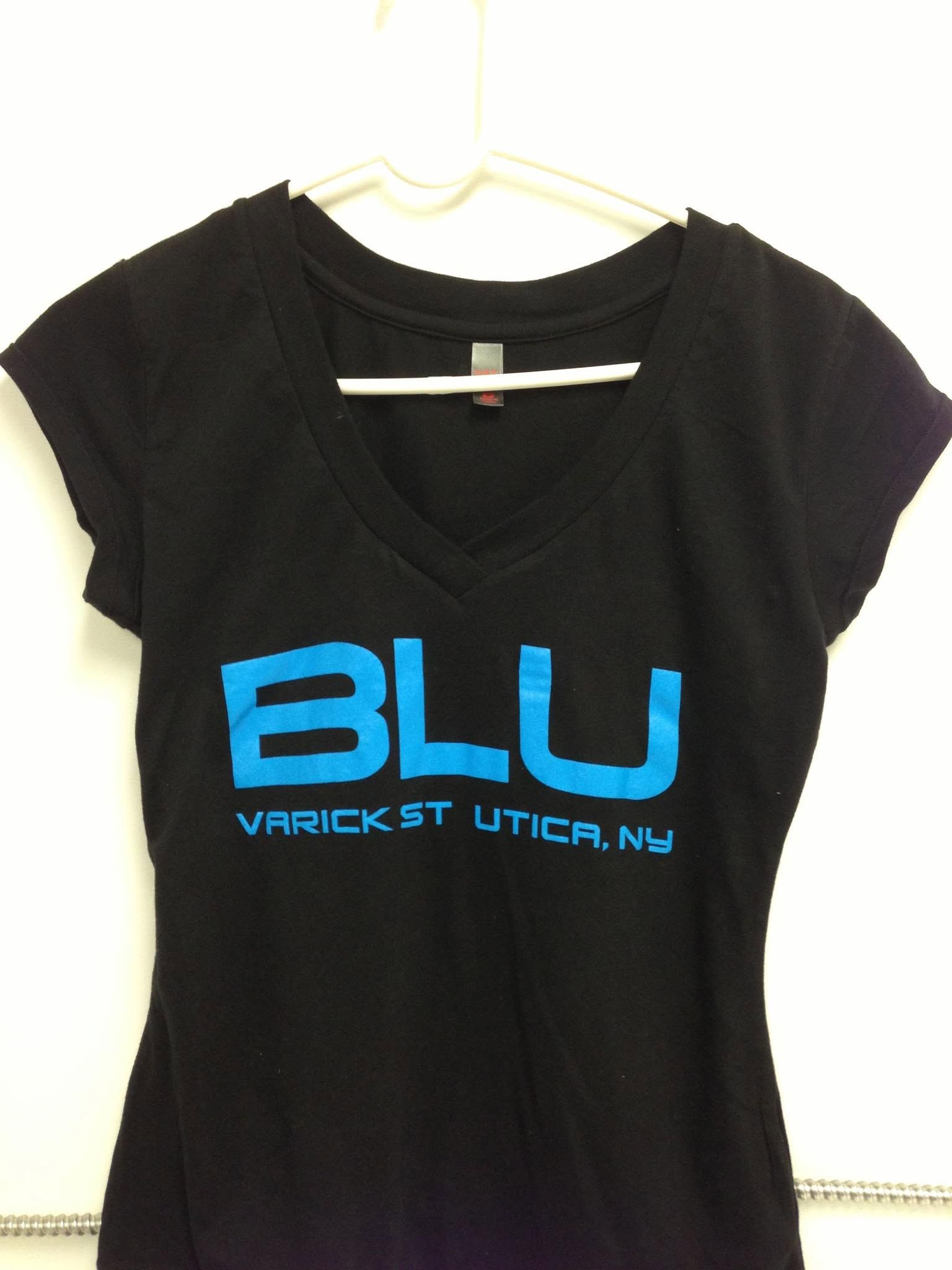 Black V-neck T-shirt on a hanger with blue “BLU” and “Varick St. Utica, NY” text