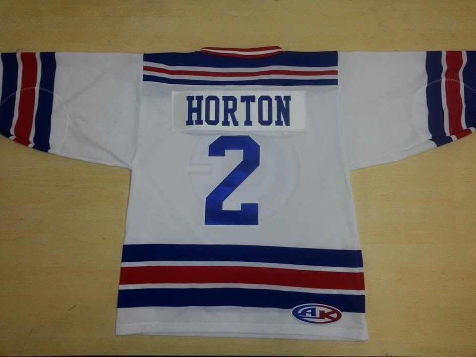 White hockey jersey with red and blue stripes, “HORTON” and number 2 on the back.